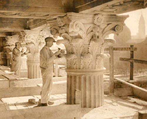 Stone carvers working on the exterior.